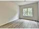 Bedroom showcasing a view from the doorway with gray wood style flooring and a window at 7760 Hansel Ln, Lithonia, GA 30058