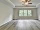 Spacious bedroom features tray ceilings, ceiling fan, and beautiful gray laminate flooring at 7760 Hansel Ln, Lithonia, GA 30058