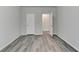 Spacious bedroom features modern gray wood flooring and neutral paint at 7760 Hansel Ln, Lithonia, GA 30058