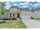 Charming two-story home features a covered front porch and attached two car garage at 7760 Hansel Ln, Lithonia, GA 30058