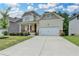 Charming two-story home features a covered front porch and attached two car garage at 7760 Hansel Ln, Lithonia, GA 30058