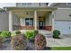 Inviting front porch with brick accents and classic columns on a two-story home at 7760 Hansel Ln, Lithonia, GA 30058