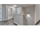 Hallway showing access to other areas and gray wood style flooring at 7760 Hansel Ln, Lithonia, GA 30058