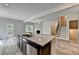 Open concept floor plan showcases a kitchen island with stainless dishwasher and backyard access at 7760 Hansel Ln, Lithonia, GA 30058