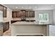 The kitchen features a center island with granite countertops, stainless appliances, and lots of natural light at 7760 Hansel Ln, Lithonia, GA 30058