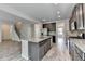 New kitchen with granite countertops, stainless appliances and an open floor plan to the living room and stairs at 7760 Hansel Ln, Lithonia, GA 30058