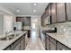 Spacious kitchen with stainless steel appliances, granite countertops, and dark wood cabinets at 7760 Hansel Ln, Lithonia, GA 30058