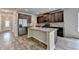 A modern kitchen features stainless appliances, granite countertops, an island, and open layout to the entry at 7760 Hansel Ln, Lithonia, GA 30058