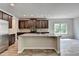 The kitchen features a center island, stainless appliances, tile backsplash and bright lighting at 7760 Hansel Ln, Lithonia, GA 30058