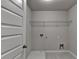 A utility sink and wire rack occupy this bright and functional laundry room at 7760 Hansel Ln, Lithonia, GA 30058
