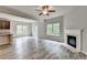 Open floor plan with wood floors, fireplace, access to the kitchen and outdoor deck, ideal for entertaining at 7760 Hansel Ln, Lithonia, GA 30058