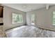 Spacious living room filled with natural light, showcasing wood floors and access to the backyard deck at 7760 Hansel Ln, Lithonia, GA 30058