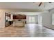 Open concept living area showcases the kitchen, and offers access to the deck with a view of surrounding trees at 7760 Hansel Ln, Lithonia, GA 30058