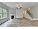 Spacious living room features a fireplace, staircase, and wood floors, creating a welcoming atmosphere at 7760 Hansel Ln, Lithonia, GA 30058