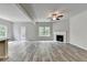 Large living area with wood floors, fireplace, ceiling fan and access to the outdoor deck at 7760 Hansel Ln, Lithonia, GA 30058