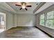 Main bedroom featuring tray ceilings, neutral paint, ceiling fan and luxury vinyl flooring at 7760 Hansel Ln, Lithonia, GA 30058