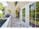 Balcony with tile flooring provides outdoor space, with table set and views of backyard at 8650 Hope Mews Ct, Sandy Springs, GA 30350