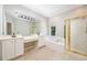 Bright bathroom features a double vanity, soaking tub, and separate shower with gold trim at 8650 Hope Mews Ct, Sandy Springs, GA 30350