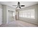 Cozy bedroom with large windows, closet with mirrored doors, and ceiling fan at 8650 Hope Mews Ct, Sandy Springs, GA 30350