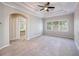 Spacious bedroom features tray ceiling, ceiling fan, plush carpet, and large windows at 8650 Hope Mews Ct, Sandy Springs, GA 30350