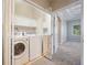 Laundry room with stacked washer and dryer units, storage and views into bedroom at 8650 Hope Mews Ct, Sandy Springs, GA 30350