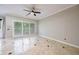 Spacious living room with large windows, ceiling fan, and stylish marble flooring at 8650 Hope Mews Ct, Sandy Springs, GA 30350