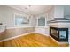 Elegant dining area featuring hardwood floors, fireplace, and a stylish light fixture at 8650 Hope Mews Ct, Sandy Springs, GA 30350