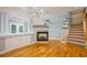 Inviting living area with fireplace, access to outdoor patio, and staircase to the upper level at 8650 Hope Mews Ct, Sandy Springs, GA 30350
