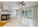 Bright living room features a fireplace, large windows, and beautiful marble floors at 8650 Hope Mews Ct, Sandy Springs, GA 30350