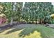 Spacious backyard with lush lawn, mature trees, and a privacy fence offers a serene outdoor space at 2123 Floral Ridge Dr, Dacula, GA 30019