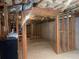 Unfinished basement space with exposed beams and framed walls at 2123 Floral Ridge Dr, Dacula, GA 30019