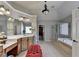 Spacious primary bathroom featuring double sinks, ample cabinetry, a glass shower and soaking tub at 2123 Floral Ridge Dr, Dacula, GA 30019