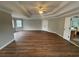 Large bedroom with trey ceilings, neutral paint, and hardwood floors at 2123 Floral Ridge Dr, Dacula, GA 30019