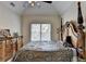 Well-lit bedroom featuring vaulted ceiling and a view of the backyard at 2123 Floral Ridge Dr, Dacula, GA 30019