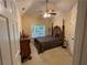 Well-lit bedroom with ceiling fan, carpet, a window, and furniture at 2123 Floral Ridge Dr, Dacula, GA 30019