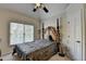 A well-lit bedroom featuring a large bed, a window, and a white door at 2123 Floral Ridge Dr, Dacula, GA 30019