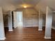 Large bonus room provides ample storage via included shelving and hardwood floors at 2123 Floral Ridge Dr, Dacula, GA 30019
