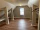 Walk-in closet featuring custom shelving, hardwood floors, and natural light at 2123 Floral Ridge Dr, Dacula, GA 30019