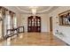 Elegant dining room featuring hardwood floors, wainscoting, a china cabinet, and a chandelier at 2123 Floral Ridge Dr, Dacula, GA 30019