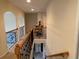 Upstairs hallway with railing overlooking the foyer and dining area at 2123 Floral Ridge Dr, Dacula, GA 30019