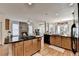 An open kitchen boasts an island, hardwood floors, granite countertops and stainless steel appliances at 2123 Floral Ridge Dr, Dacula, GA 30019