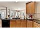 Kitchen featuring a dishwasher, sink, wooden cabinets and tiled countertops at 2123 Floral Ridge Dr, Dacula, GA 30019