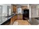 Kitchen with stainless steel appliances, hardwood flooring and dark granite countertops at 2123 Floral Ridge Dr, Dacula, GA 30019