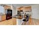 Open kitchen with granite countertops, stainless appliances, island and hardwood floors at 2123 Floral Ridge Dr, Dacula, GA 30019