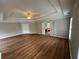 Open living room featuring hardwood floors, trey ceiling, and access to the bathroom at 2123 Floral Ridge Dr, Dacula, GA 30019