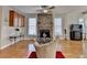 An inviting living room with fireplace, hardwood floors, and ample natural light from large windows at 2123 Floral Ridge Dr, Dacula, GA 30019