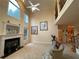 Spacious living room featuring a fireplace, tall windows, and a soaring two-story ceiling at 2123 Floral Ridge Dr, Dacula, GA 30019