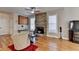 An inviting living room with fireplace, hardwood floors, and ample natural light from large windows at 2123 Floral Ridge Dr, Dacula, GA 30019
