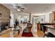 An inviting living room with fireplace, hardwood floors, and ample natural light from large windows at 2123 Floral Ridge Dr, Dacula, GA 30019