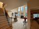Elegant living room featuring a fireplace, bright windows, staircase, and open access to other areas at 2123 Floral Ridge Dr, Dacula, GA 30019